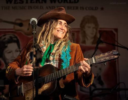 Melissa Carper playing guitar on stage at the Continental Club's Western World