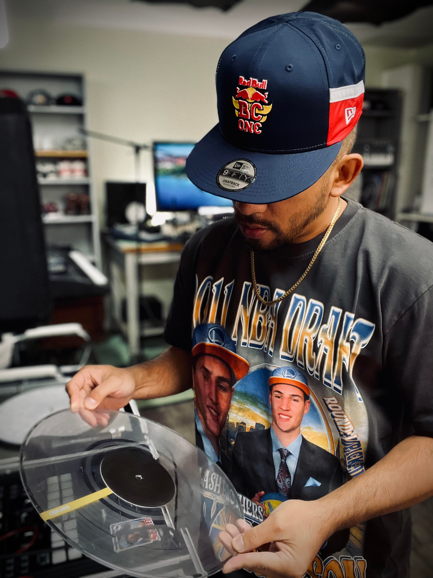 Bboy Wicket cueing up a clear vinyl record on his turntables