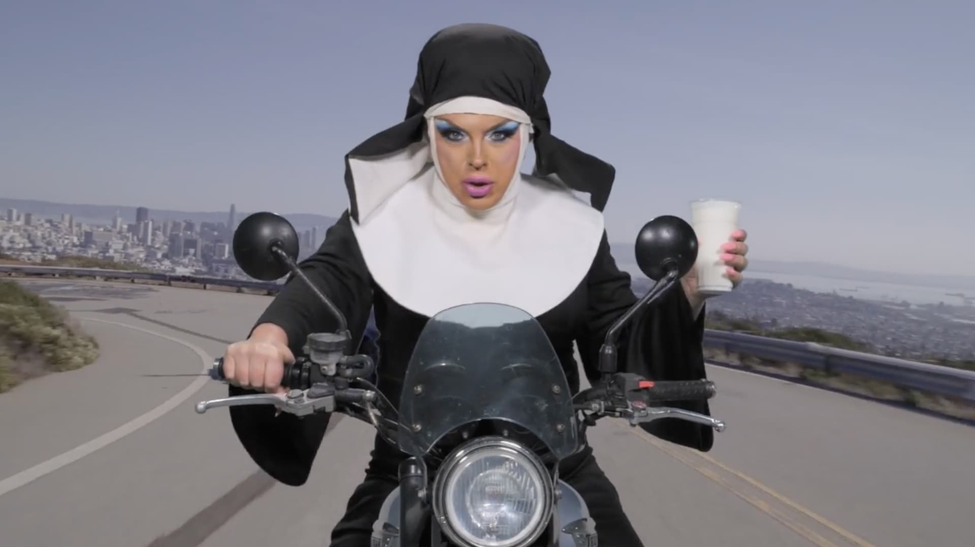 D'Arcy Drollinger in a nun's habit riding a motorcycle above San Francisco in Lady Champagne