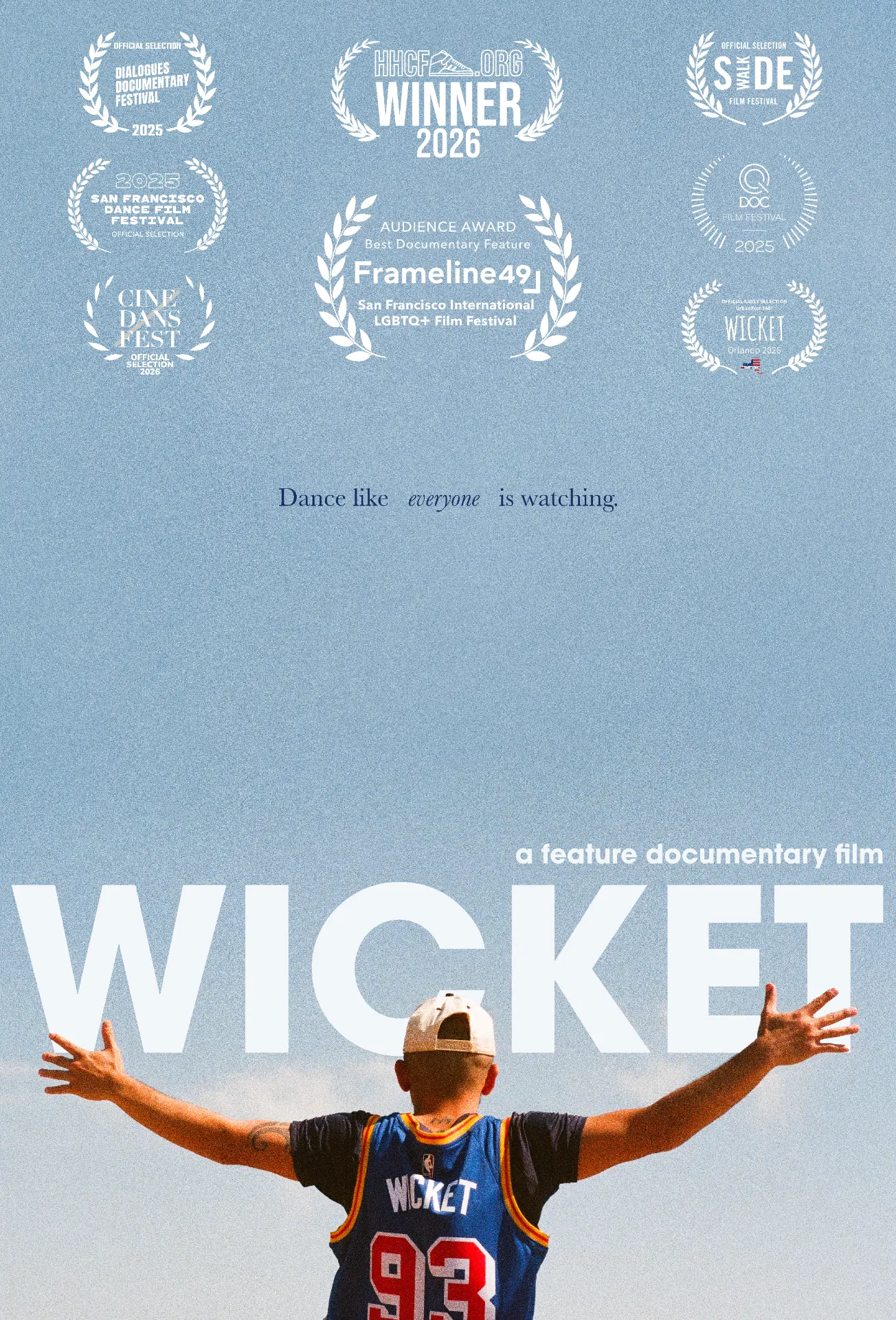 WICKET documentary poster: Bboy Wicket seen from behind with arms outstretched against a pale blue sky, tagline 'Dance like everyone is watching.'