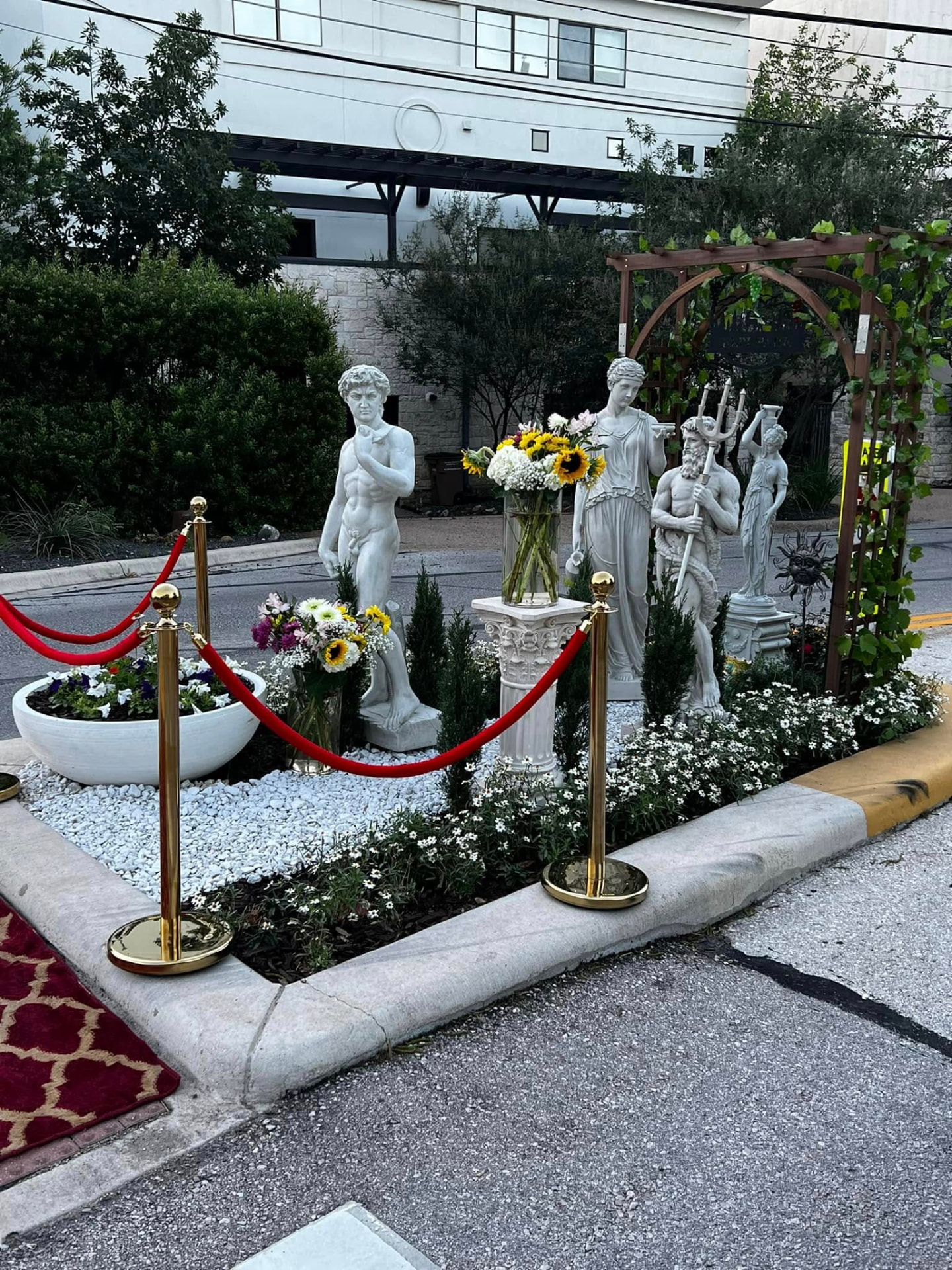 Marble statues, sunflowers and a grape arbor arranged on the BEPI Park traffic median